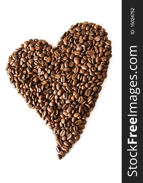 Roasted coffee grains lying in the shape of the heart. Roasted coffee grains lying in the shape of the heart