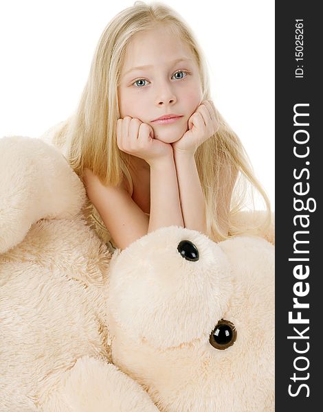 The beautiful girl embraces a plush bear