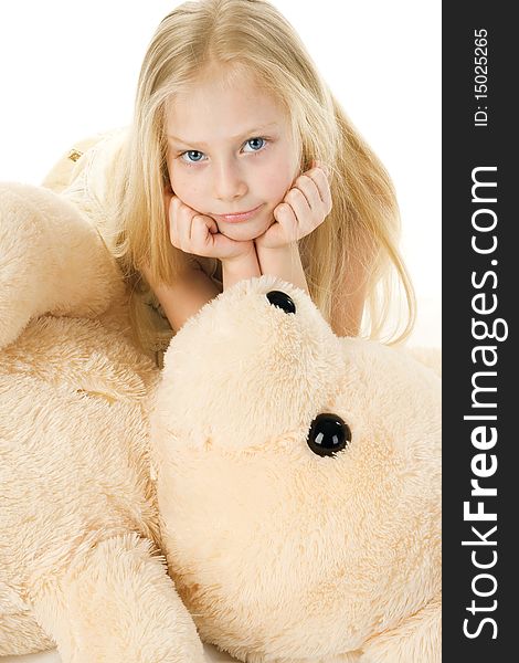 The beautiful girl embraces a plush bear