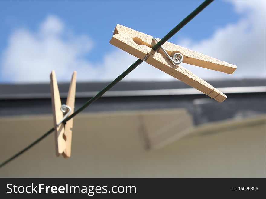 Picture of two clothespins on clothes line.