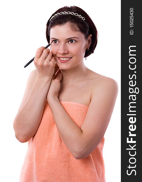 Brunette woman using eyeliner on her eyes