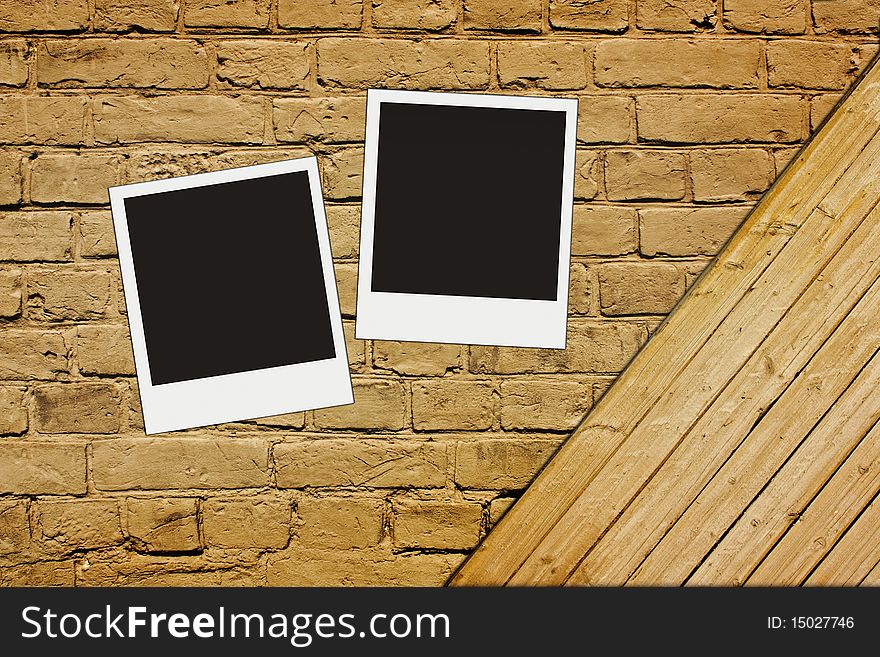 Blank photos on vintage brown textured brick and wooden wall