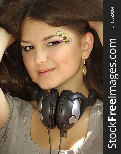 Young beautiful girl relaxing and listening to music. Young beautiful girl relaxing and listening to music