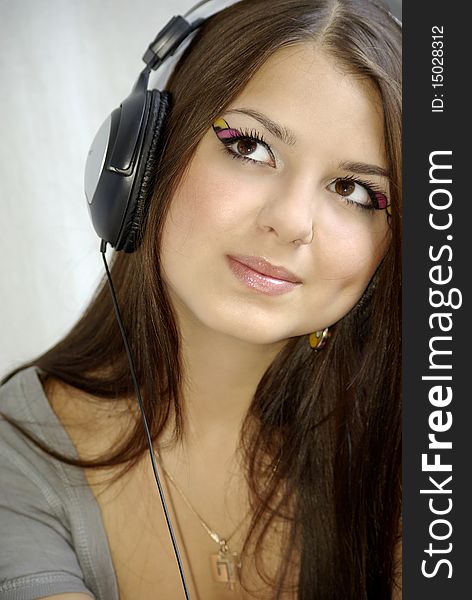 Young beautiful girl relaxing and listening to music