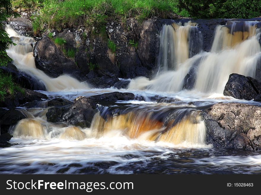 Cold forest waterfall at rocks