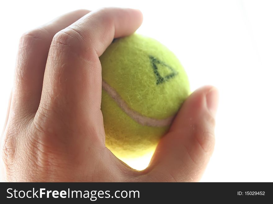 Marked tennis ball in a hand