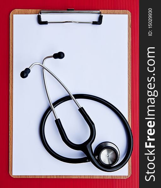 A blank clipboard with a stethoscope for medical personal. A blank clipboard with a stethoscope for medical personal.