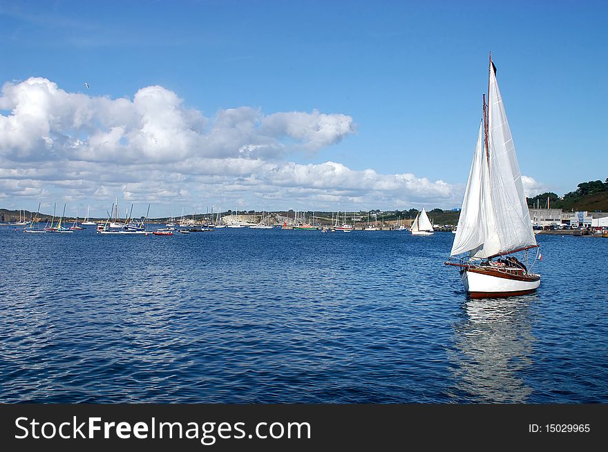 Maneuver a sailboat in the harbor of Camaret in Brittany- France. Maneuver a sailboat in the harbor of Camaret in Brittany- France