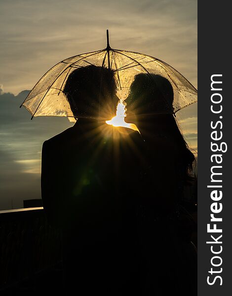 Silhouette couple prewedding under umbrella