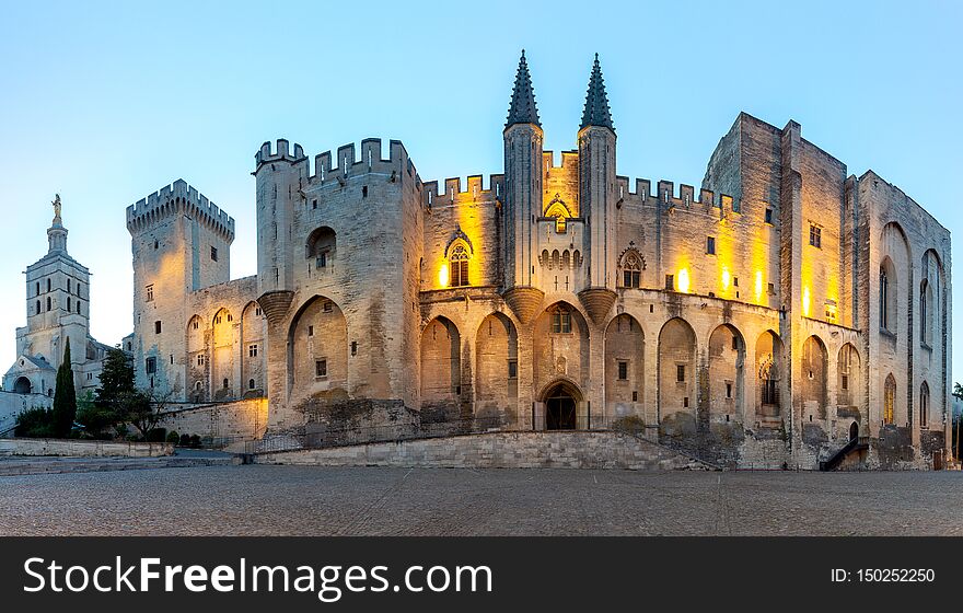 Panorama of the building of the famous medieval papal palace at dawn. Avignon. France. Panorama of the building of the famous medieval papal palace at dawn. Avignon. France.