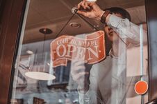 Man Is Putting Nameplate About Opening At His Own Shop. Royalty Free Stock Photos