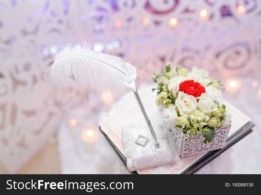Wedding ceremony. Two golden wedding rings laying on tray of roses. accessories for the bride and groom. Preparation for