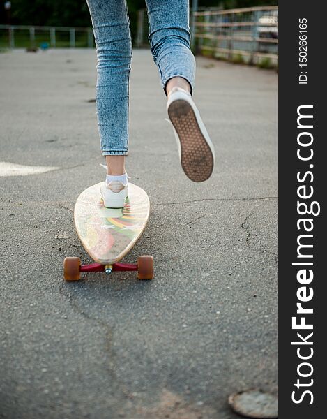 Girl with longboard wearing sneakers shoes in urban style and fashion lifestyle