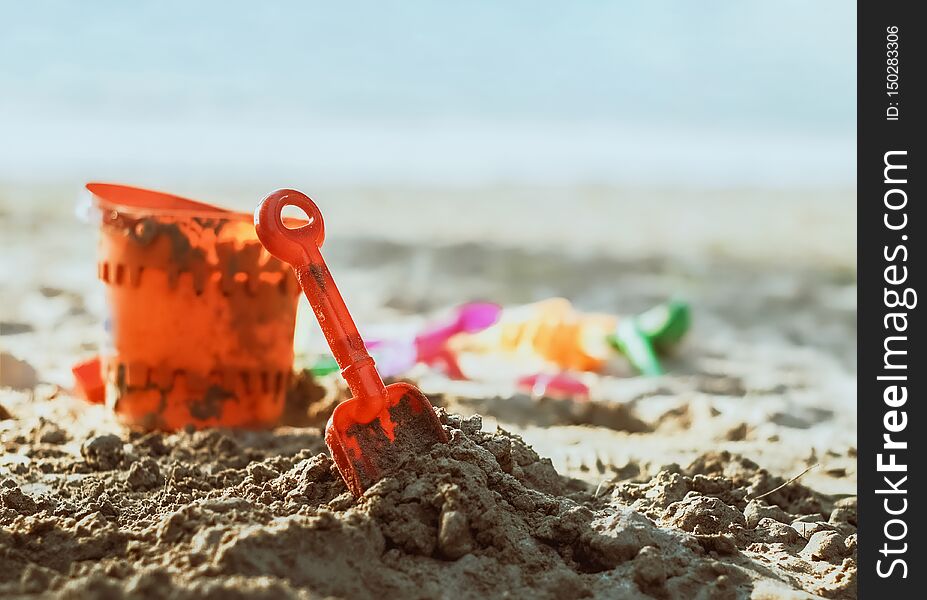 Plastic toys on sandy beach