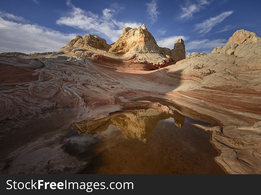 Red Rock Formation at sunrise, with reflection in the pond, at White Pocket, Vermilliom Cliffs National Monument, Arizona, USA. Red Rock Formation at sunrise, with reflection in the pond, at White Pocket, Vermilliom Cliffs National Monument, Arizona, USA