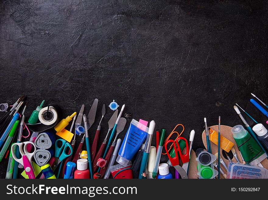 School Supplies On Blackboard Background