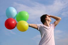 Young Man With Many Colored Balloons Royalty Free Stock Image