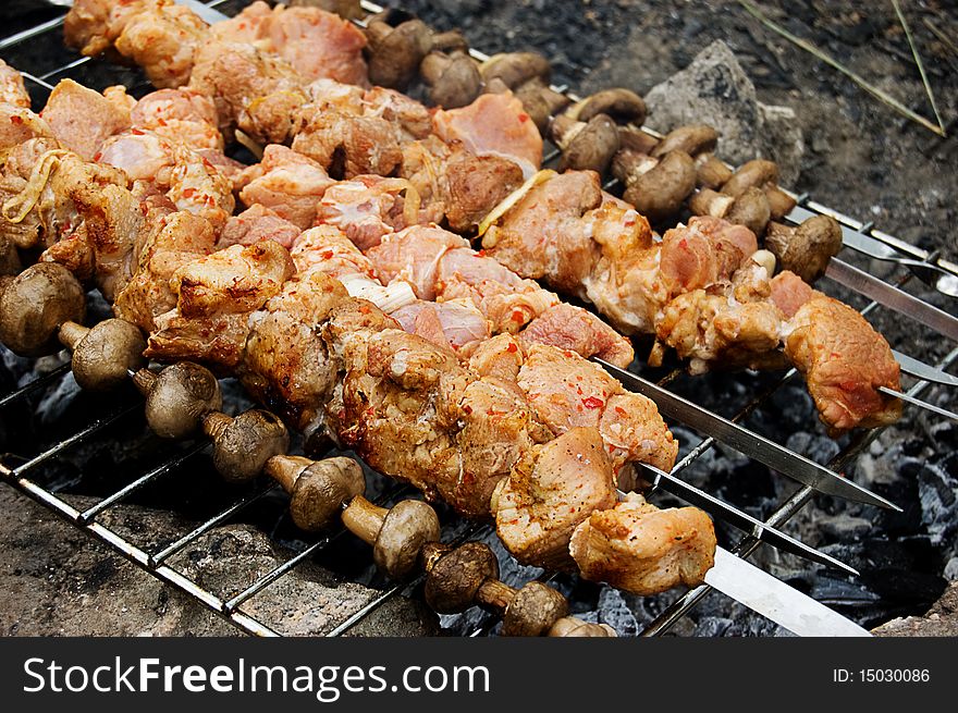 Barbecue with grilled meat and mushrooms