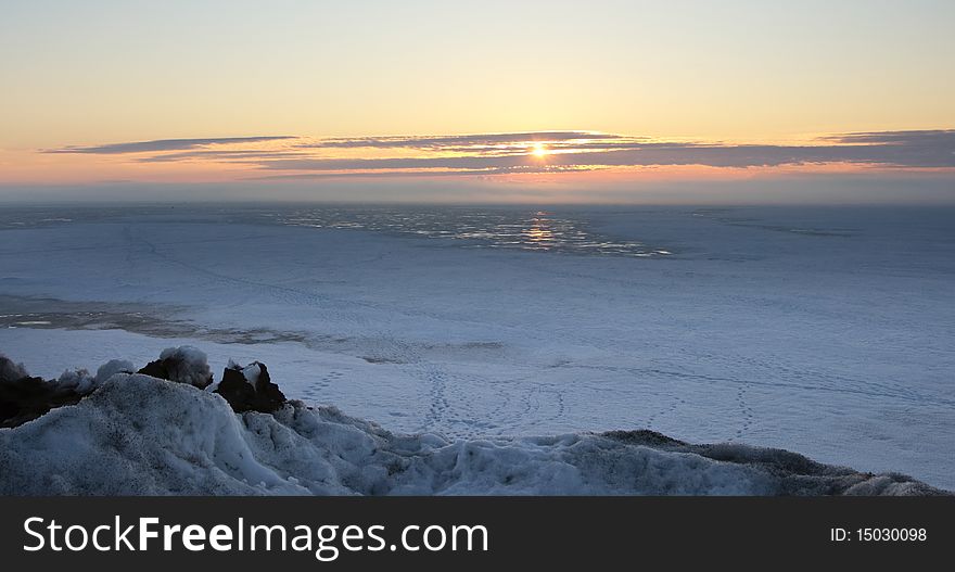 Sunrise over a water basin in the winter