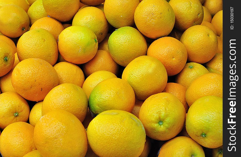 A pile of fresh unpeeled oranges shot at a Hong Kong market
