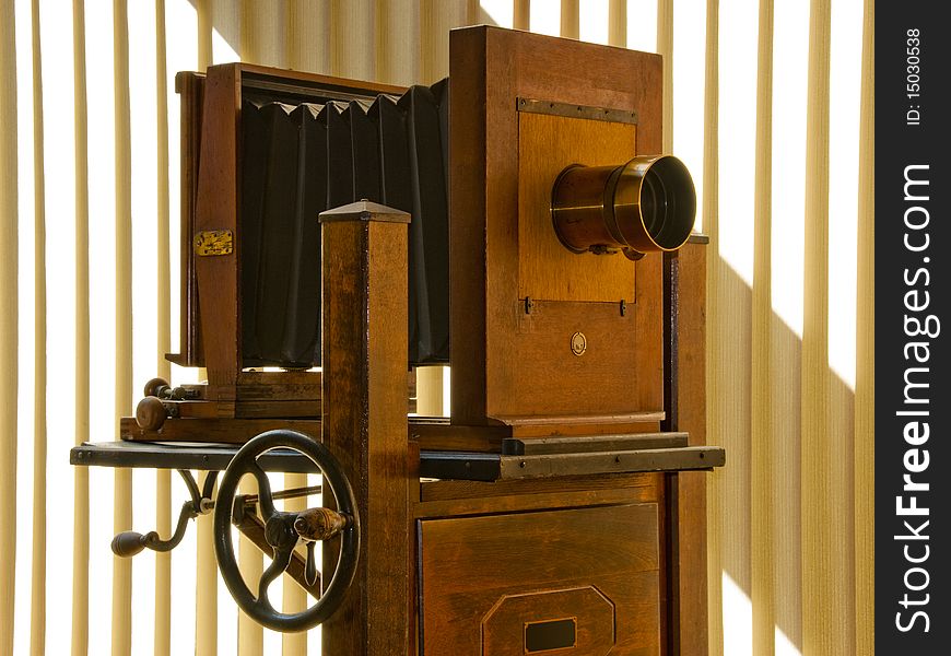 Antique mahogany wood studio camera on rolling stand