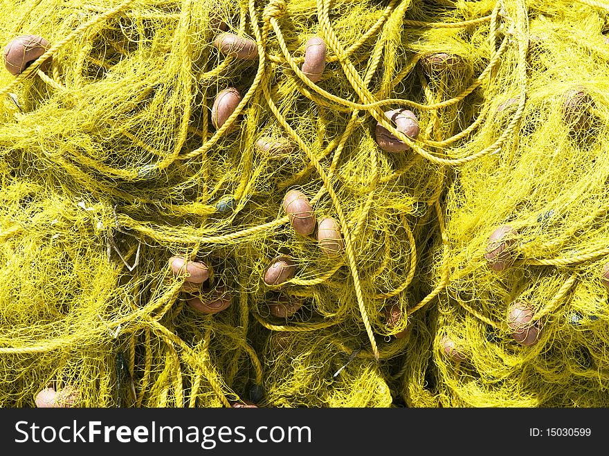 Pile of yellow fishing nets in Greece
