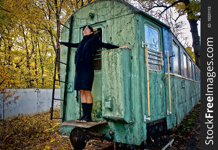 Woman strands on back side of old squalid rail coach. Woman strands on back side of old squalid rail coach