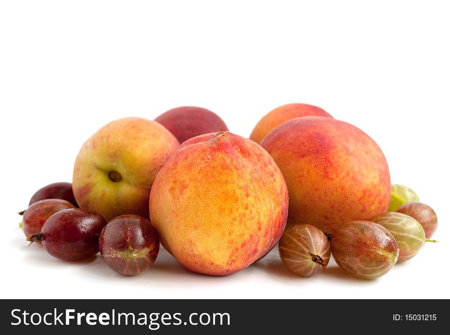 Ripe, juicy peach and gooseberry on a white background