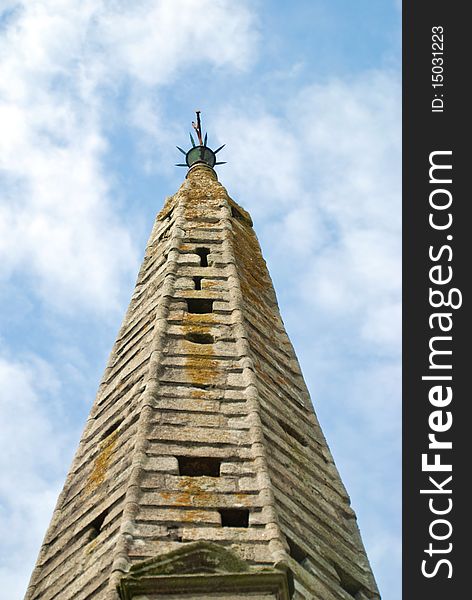 Spire of old steeple in brittany - blue sky. Spire of old steeple in brittany - blue sky