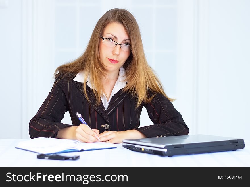 Business woman with laptop on a light background