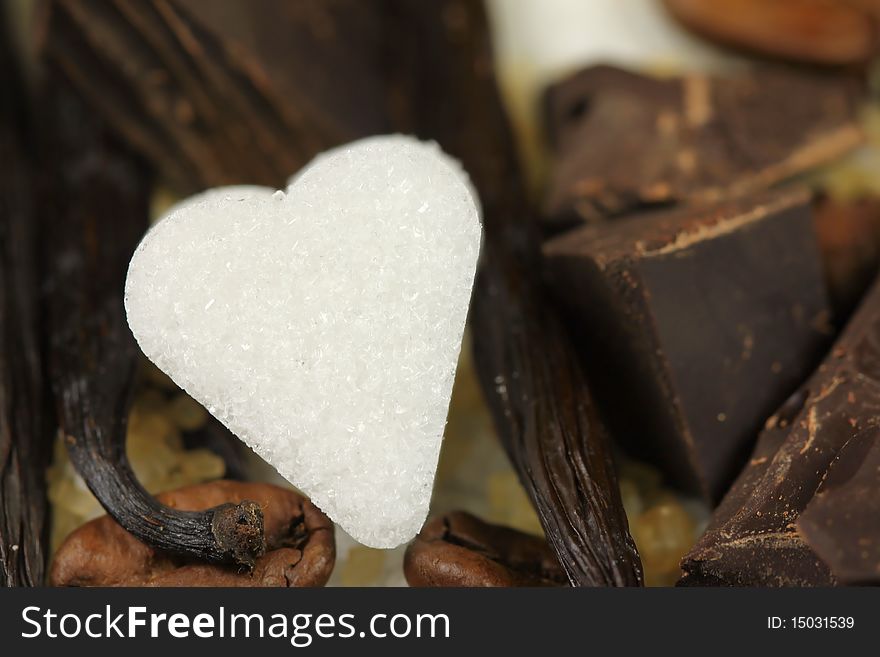 White sugar heart with delicious ingredients - vanilla, coffeee and chocolate