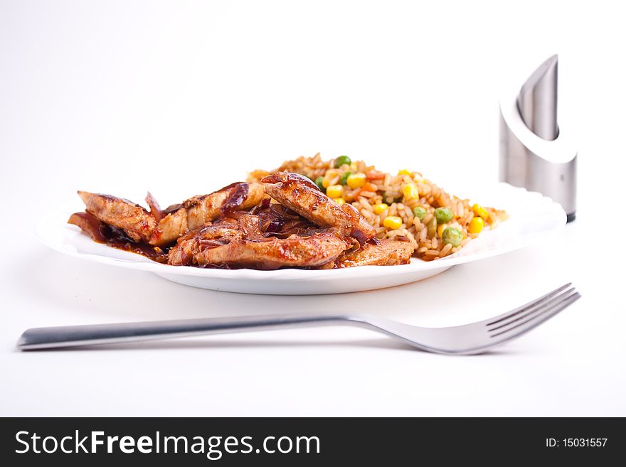 Stifried vegetable rice with soy and spices and fried pork with onions and tomatos. Stifried vegetable rice with soy and spices and fried pork with onions and tomatos