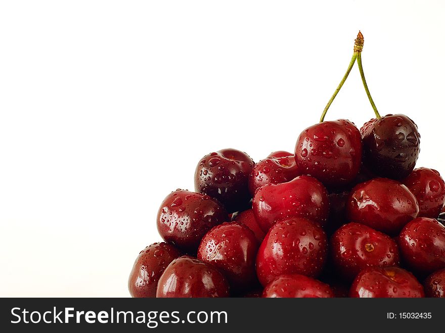 Sprinkled with water cherries on the white background. Sprinkled with water cherries on the white background