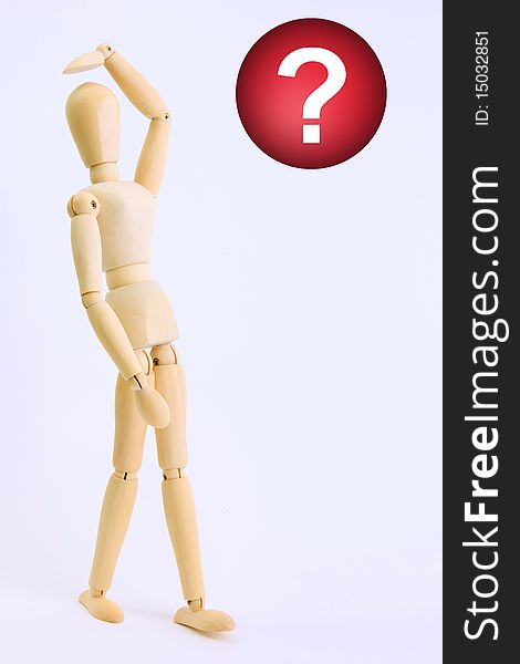 Wooden doll looking a red question symbol. Wooden doll looking a red question symbol