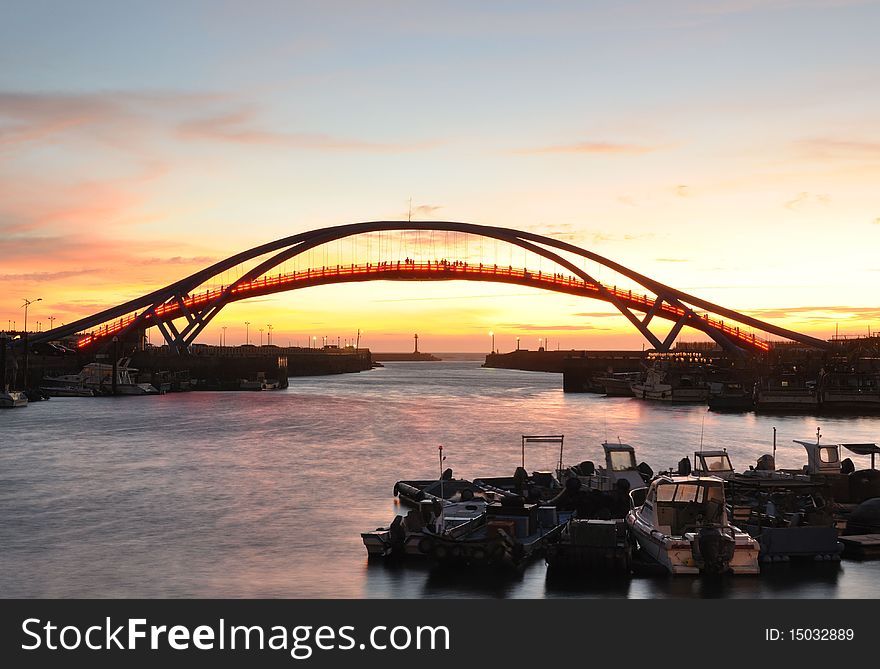 A beautiful sunset at the port with a bridge. A beautiful sunset at the port with a bridge