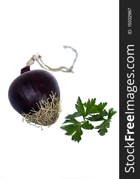 Single red onion isolated with parsley on white background.