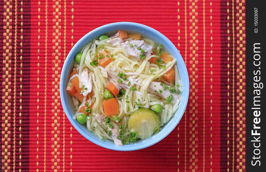 Bowl of chicken soup with noodles and vegetables