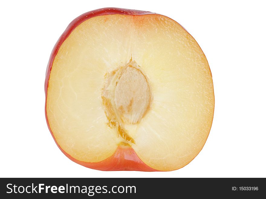 Plum cut fifty-fifty with pit on white background