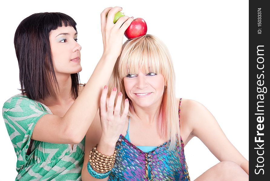 Two young pretty women posing with apples, studio shot