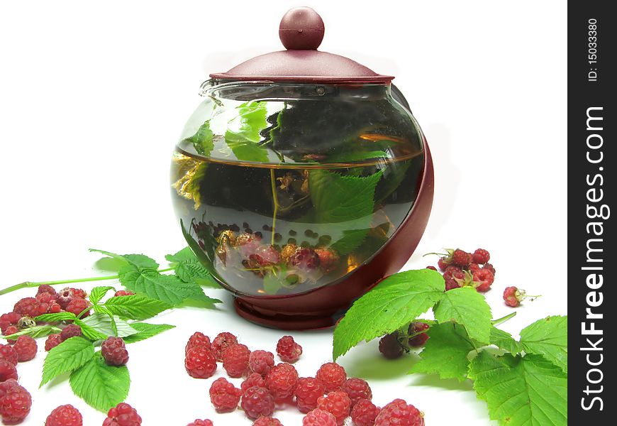 Teapot among fresh raspberry