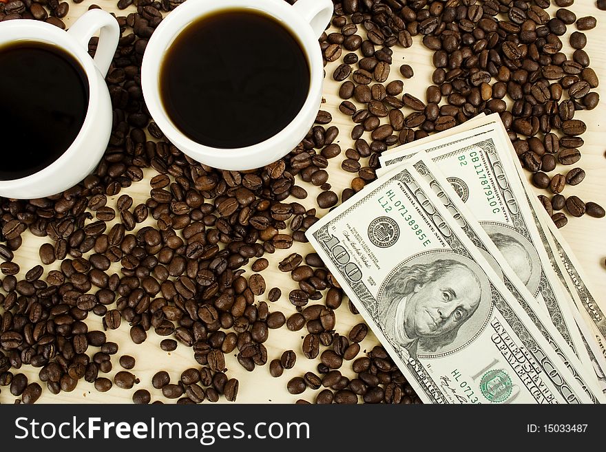 Aromatic coffee in white cup with coffee beans scattered and dollars. Aromatic coffee in white cup with coffee beans scattered and dollars