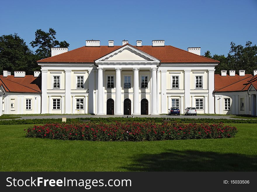 Classical palace with the garden into a sunny day