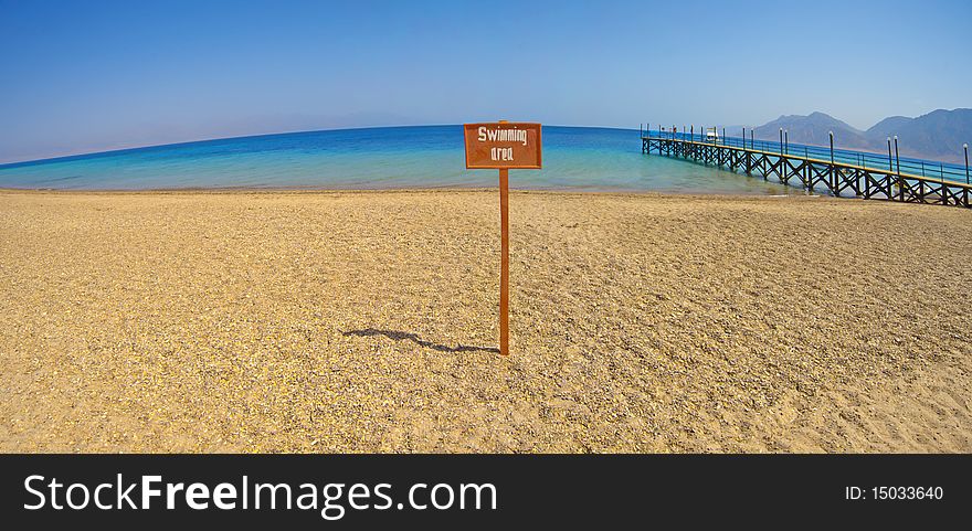 Panoramic view from a tropical beach with swimming area sign. Panoramic view from a tropical beach with swimming area sign