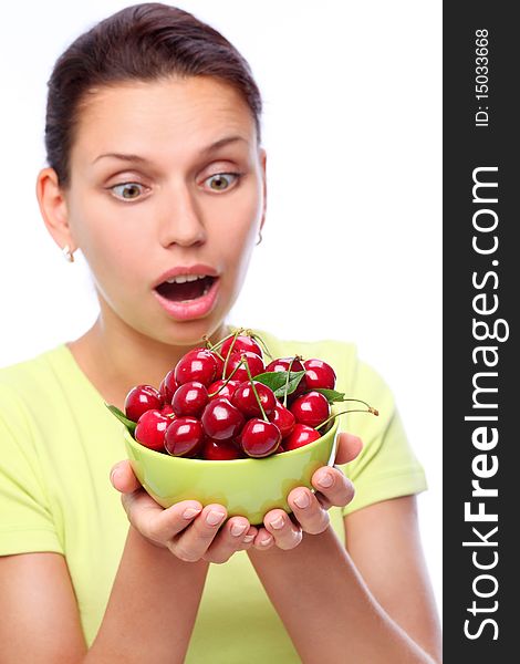 Woman with crockery of cherries in her hands.
