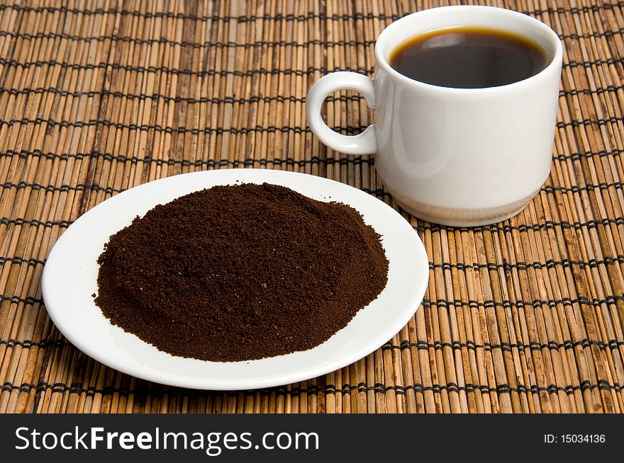 Cup of coffee with ground beans