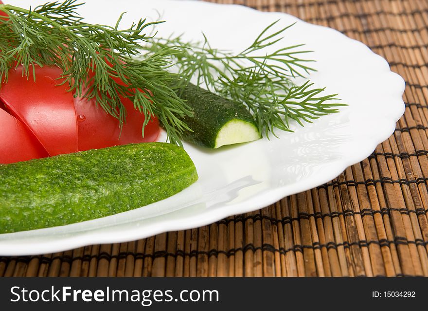 Macro of plate with tomotoes and cucumbers. Macro of plate with tomotoes and cucumbers