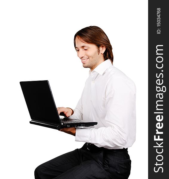 Young happy businessman working on his laptop computer