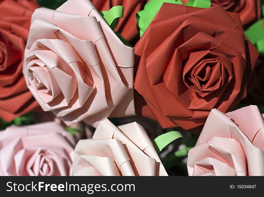 A macro picture of pink and red paper roses