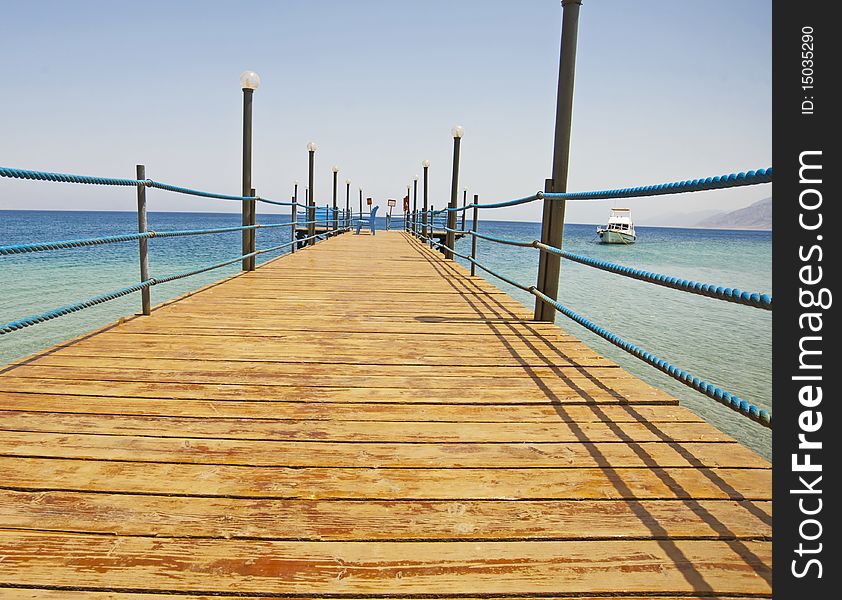 Wooden Jetty On A Tropical Beach