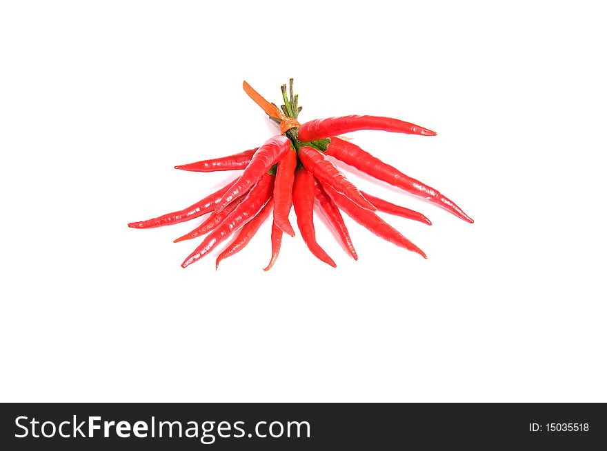 Red peppers connected by ribbon isolated on a white background. Red peppers connected by ribbon isolated on a white background.